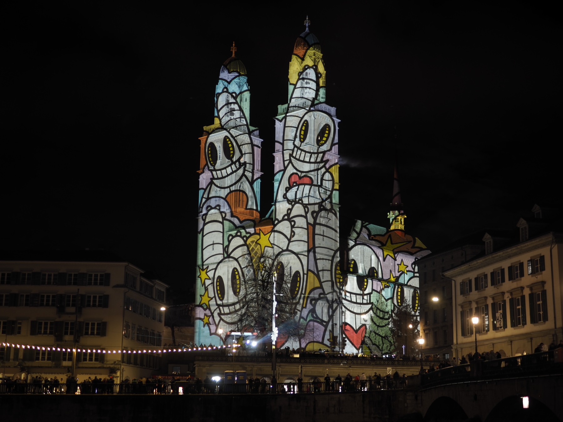 Art projected from across the river onto the Grossmünster