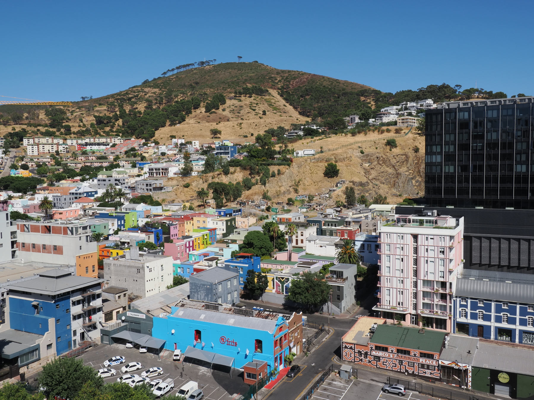 Bo-Kaap area with the multi coloured houses. Squatters on the slope just above them