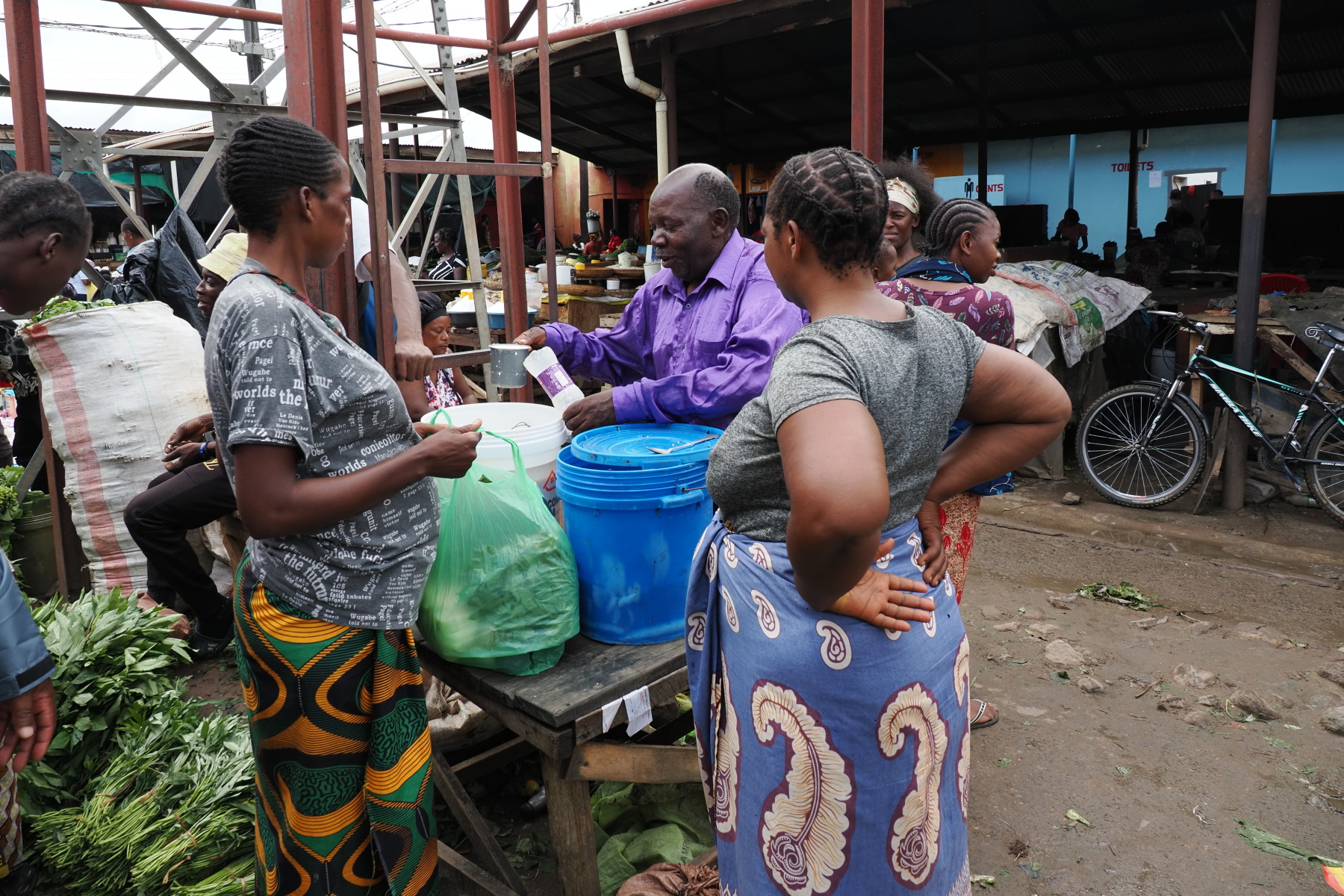 measuring sour milk for sale at the market