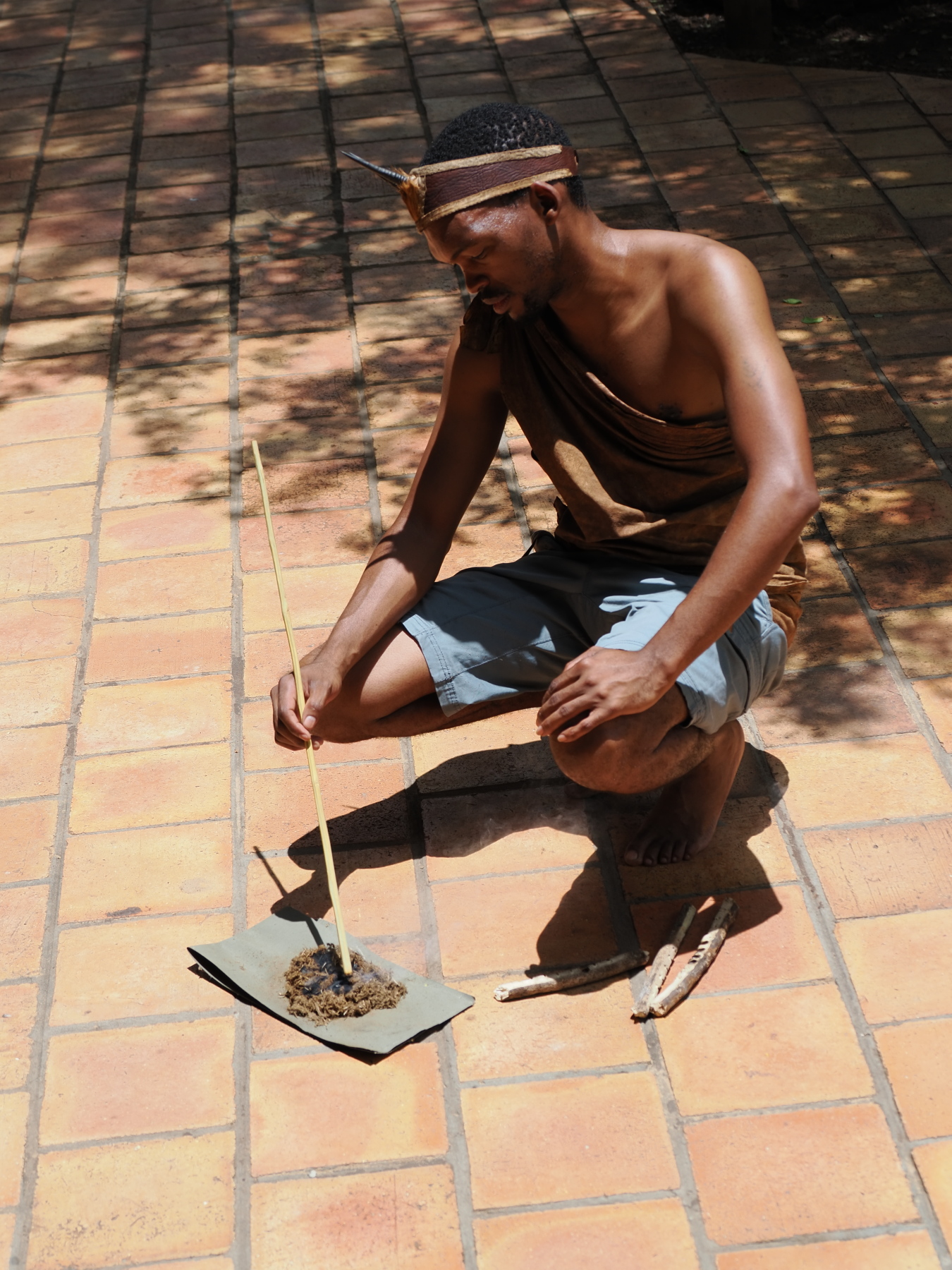 Q, the former bushman and now a camp employee, starting a fire