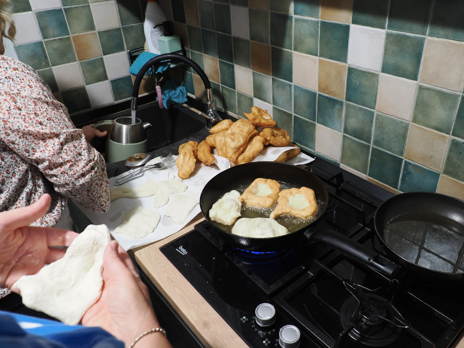 mkaing frybread - unleavened bread dough into a fry pan with canola oil
